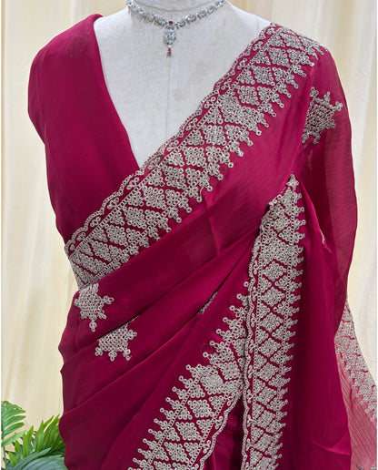 Rose pink georgette saree with golden white embroidery .