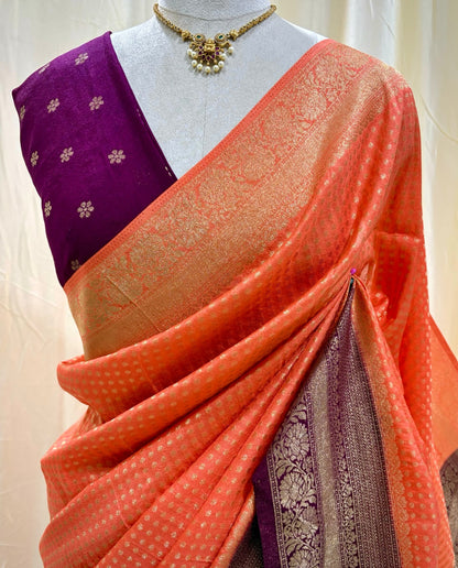 Saffron chiffon saree with magenta border.