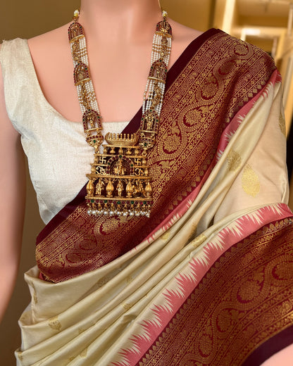 Ivory white art silk saree with reddish maroon temple border.
