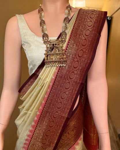 Ivory white art silk saree with reddish maroon temple border.