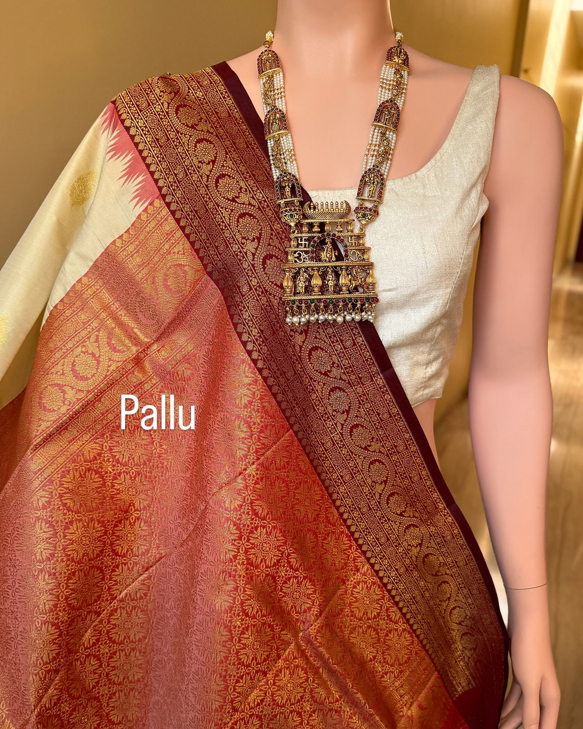 Ivory white art silk saree with reddish maroon temple border.