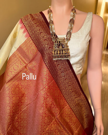 Ivory white art silk saree with reddish maroon temple border.