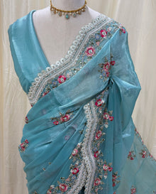 Sky blue golden yellow organza saree with white embroidery border.