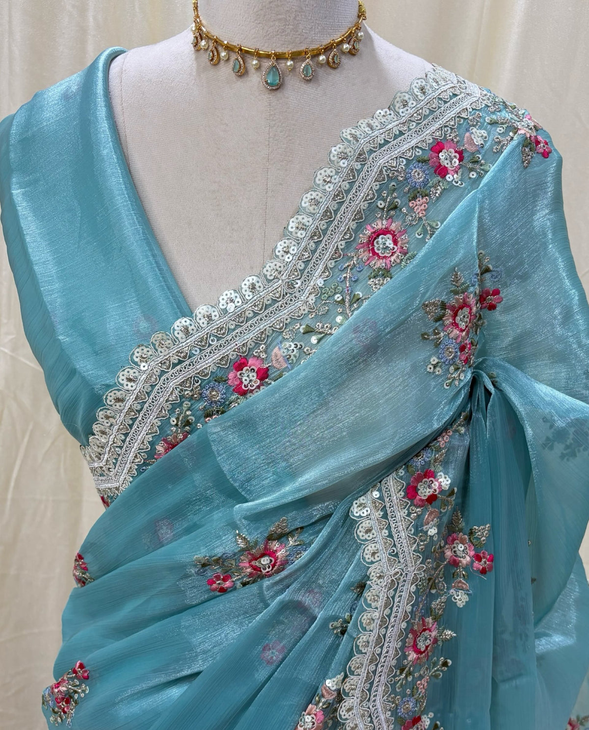 Sky blue golden yellow organza saree with white embroidery border.