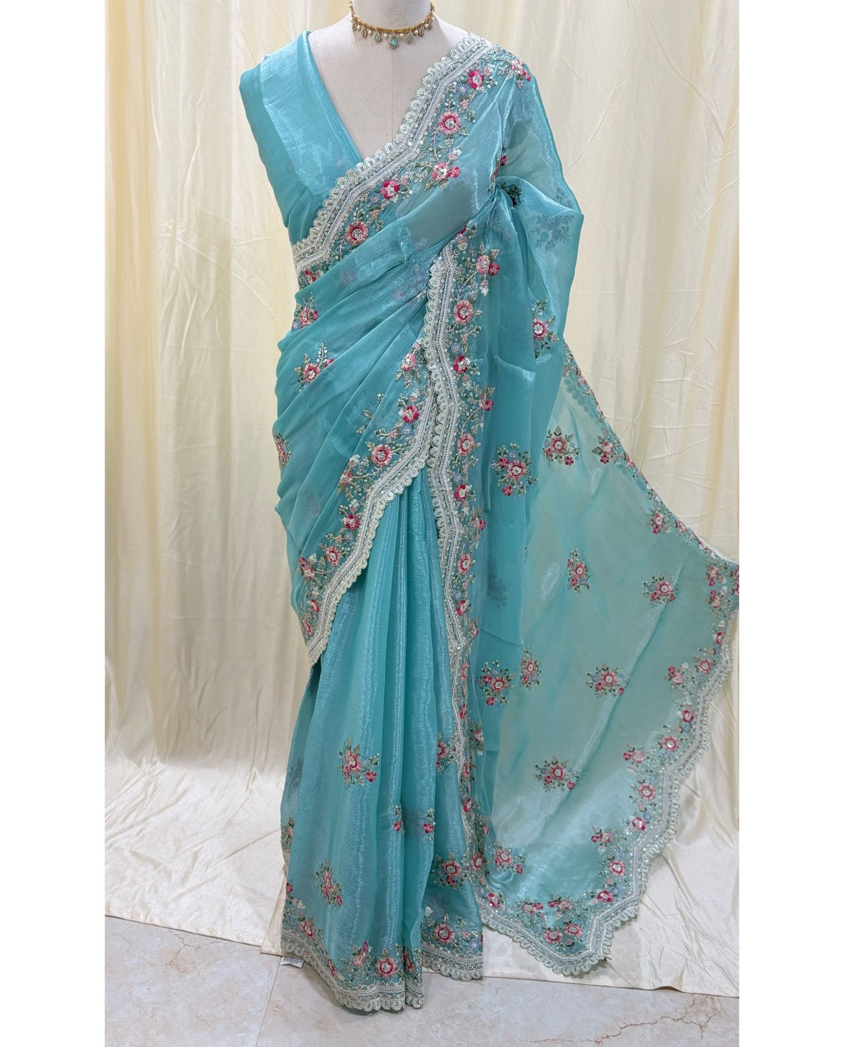 Sky blue golden yellow organza saree with white embroidery border.