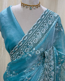 Sky blue soft organza saree with white embroidery all over saree.