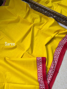 YELLOW COTTON PRINTED SAREE COMES WITH CONTRAST RED BORDER