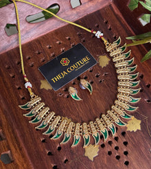 Antique gold choker with elegant green necklace.