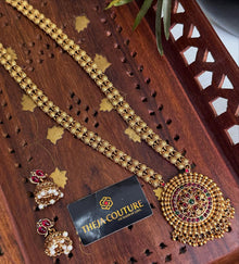 Long haram with a floral pendant and matching  jhumkas.