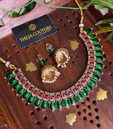 Short green antique gold necklace.