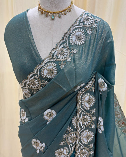 Teal blue georgette saree with white embroidery.