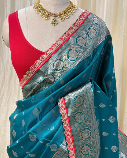 Teal blue satin ailk saree with red lace.
