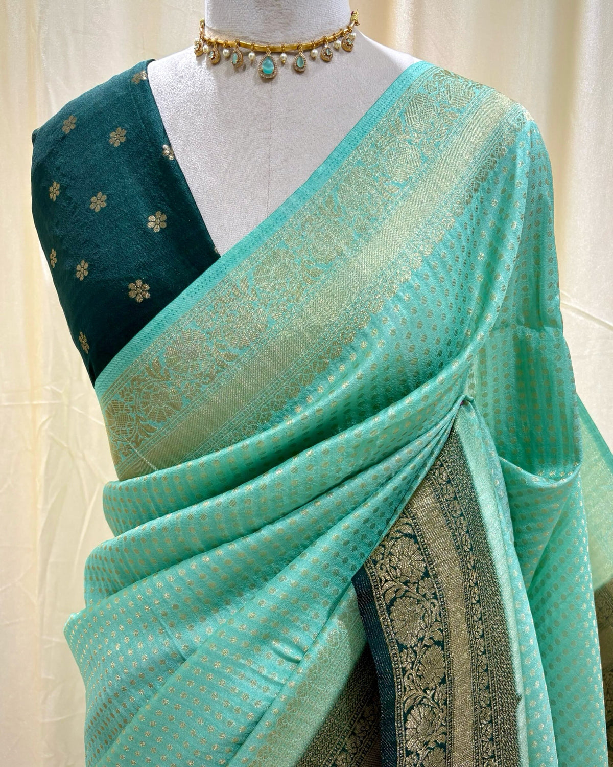 Turquoise blue chiffon saree with bottle green border