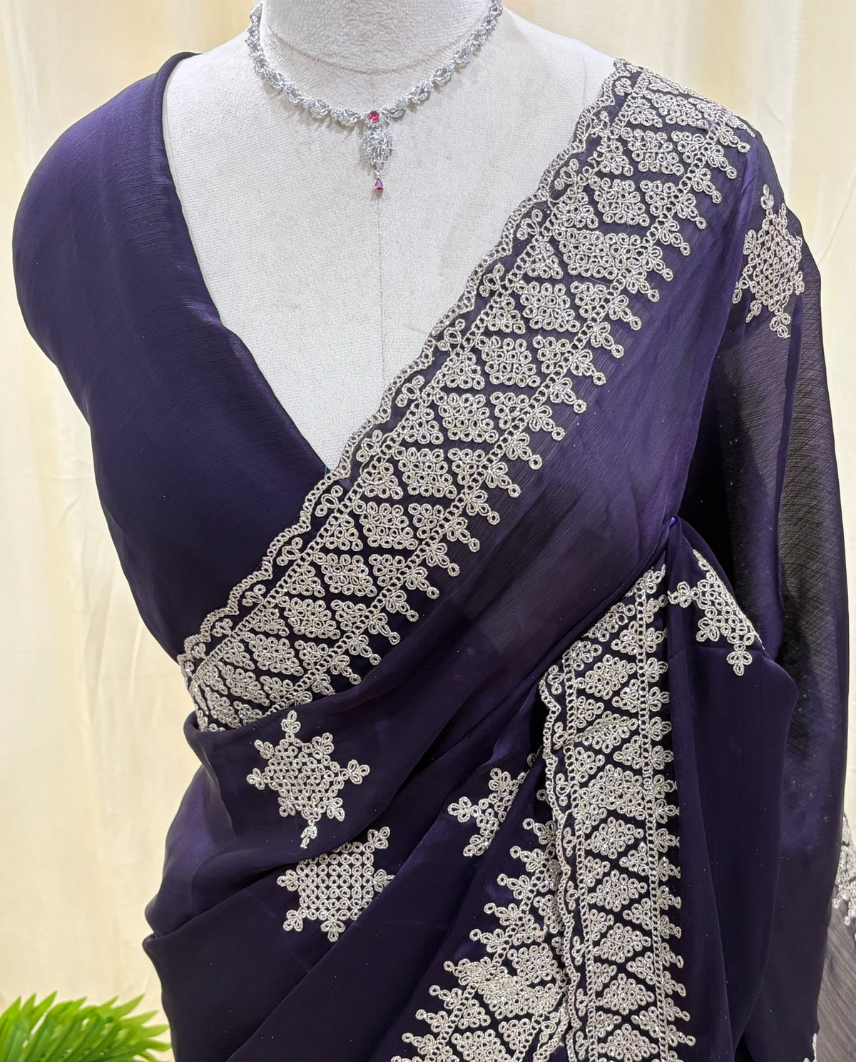 Violet georgette saree with golden white embroidery.