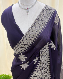Violet georgette saree with golden white embroidery.