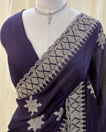 Violet georgette saree with golden white embroidery.