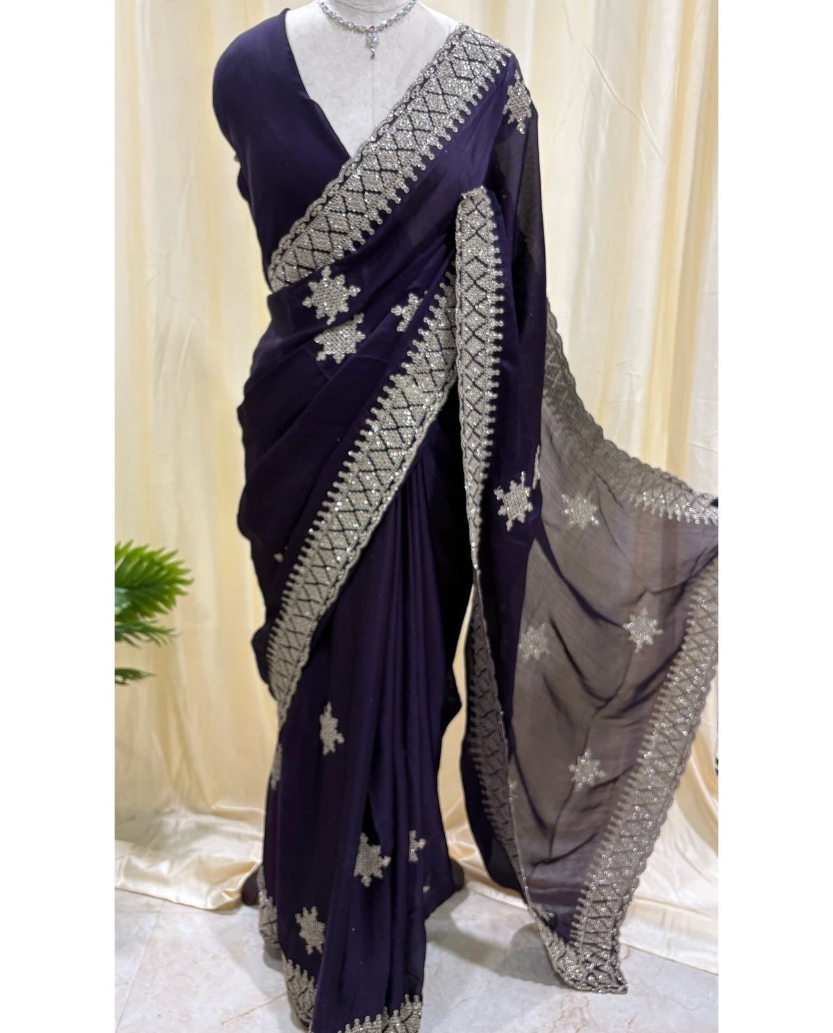 Violet georgette saree with golden white embroidery.