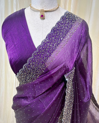 Violet georgette saree with white stones.
