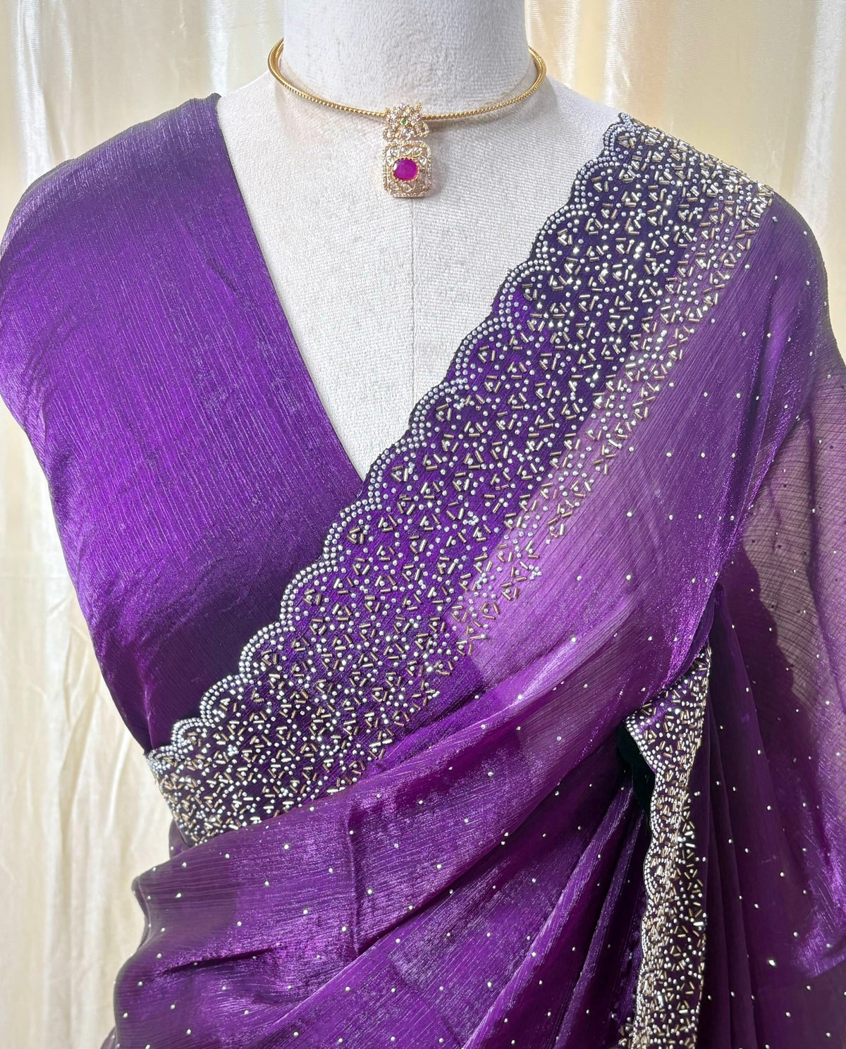 Violet georgette saree with white stones.