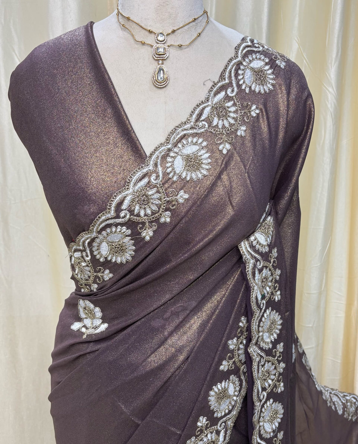 Wine gold georgette saree with white embroidery .