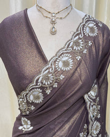 Wine gold georgette saree with white embroidery .