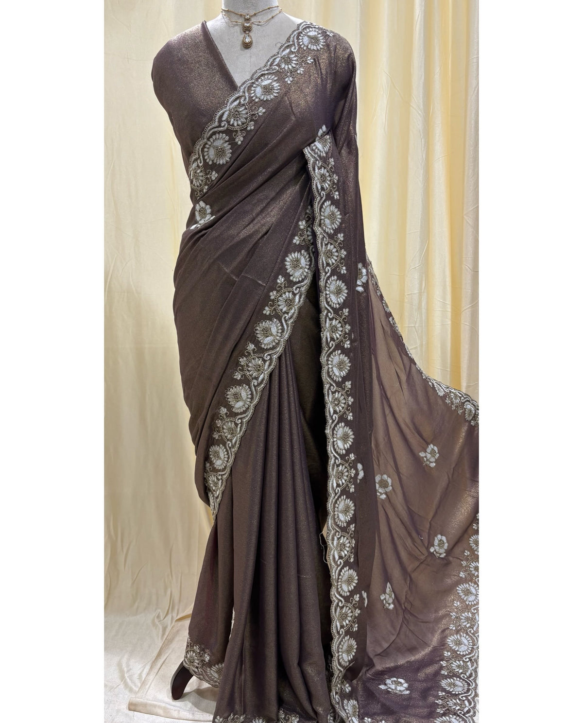 Wine gold georgette saree with white embroidery .