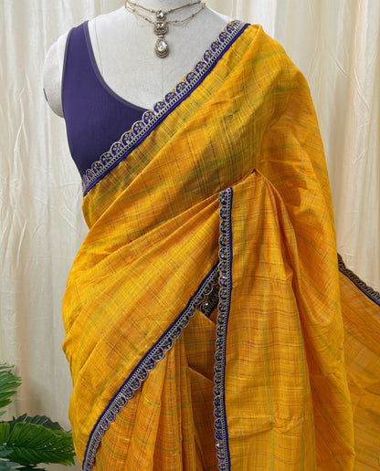 Yellow dupion silk saree with violet border.