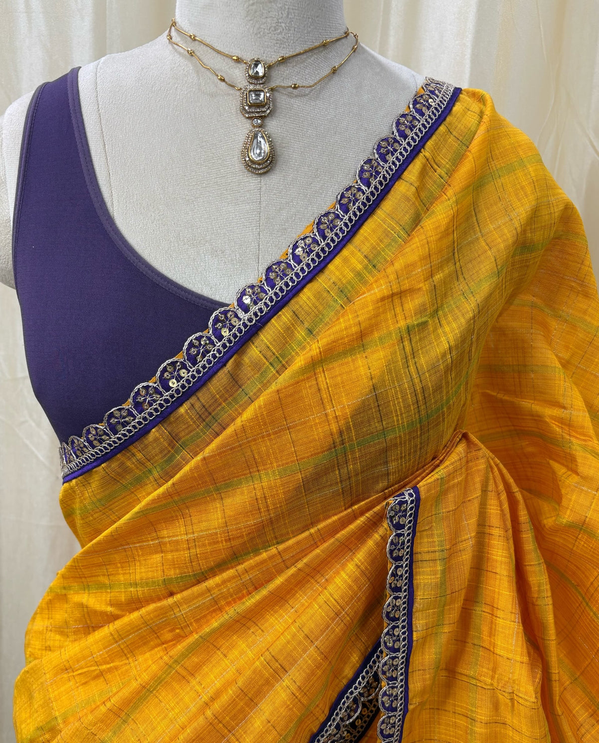 Yellow dupion silk saree with violet border.
