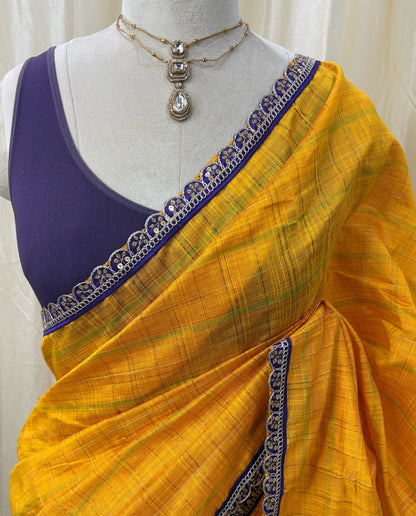 Yellow dupion silk saree with violet border.