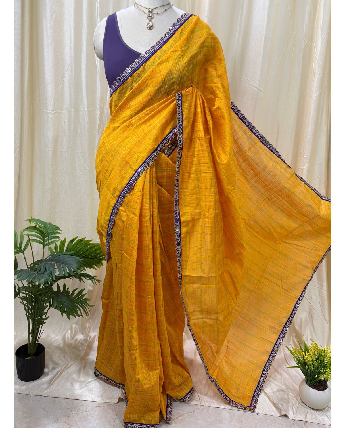 Yellow dupion silk saree with violet border.