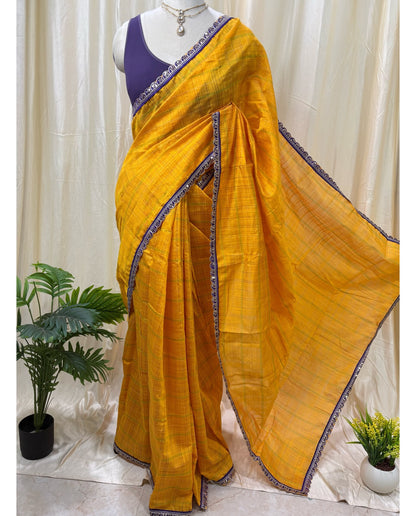 Yellow dupion silk saree with violet border.