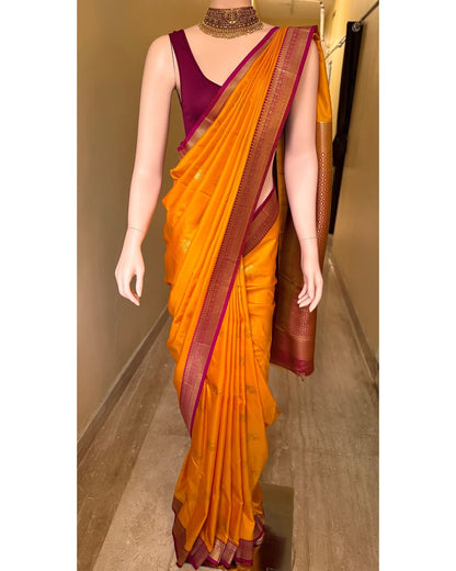 Mango yellow art silk saree with magenta pink border.